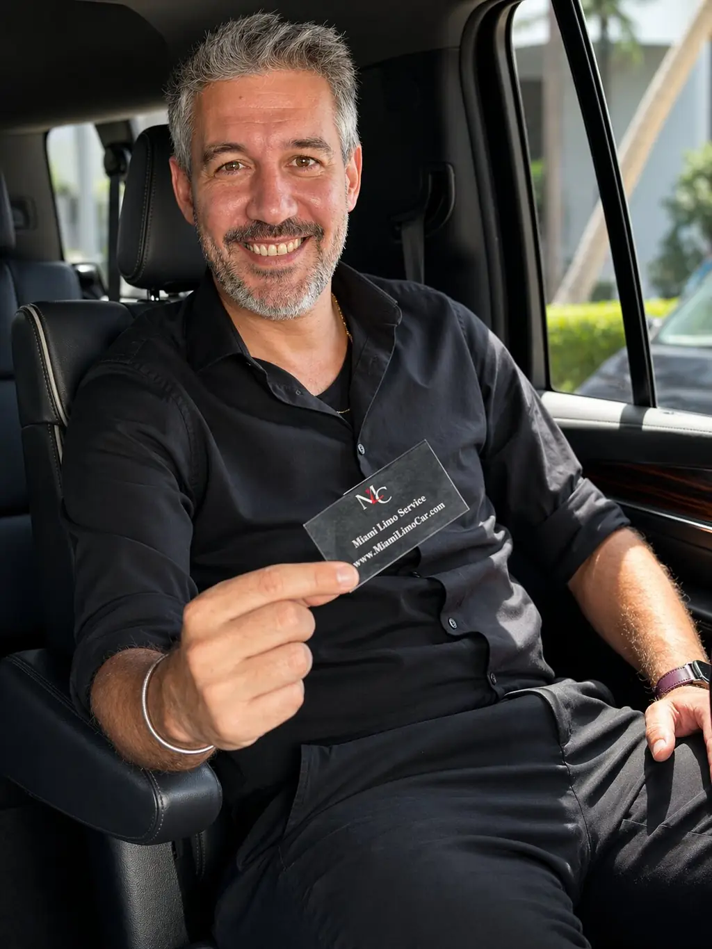 Miami Limo Car chauffeur holding a business card